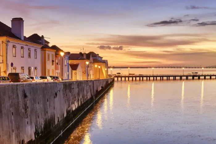 Framed Print : The traditional fishing village of Alcochete at sunset, spreading along the river Tagus Framed Print : The traditional fishing village of Alcochete at sunset, spreading along the river Tagus