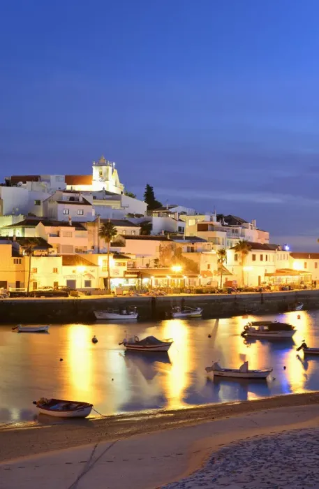 Framed Print : The traditional fishing village of Ferragudo at dusk, bordering the Arade river. Algarve Framed Print : The traditional fishing village of Ferragudo at dusk, bordering the Arade river. Algarve