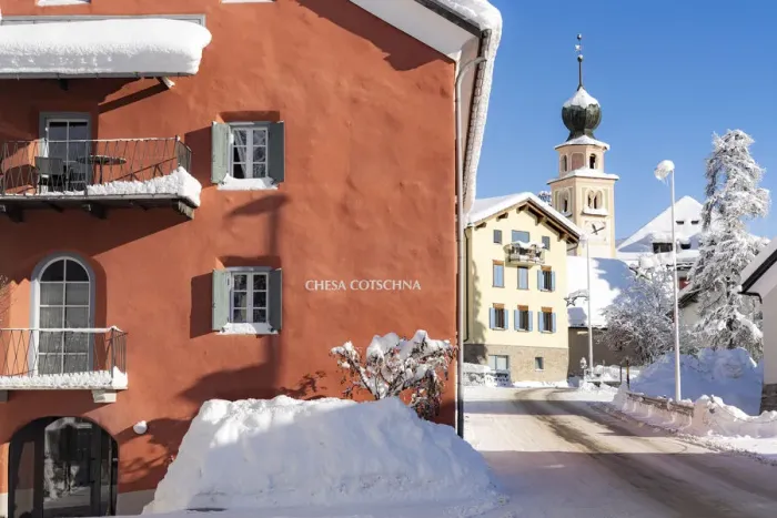 Framed Print : Traditional house and church in Madulain village covered with snow in winter Framed Print : Traditional house and church in Madulain village covered with snow in winter