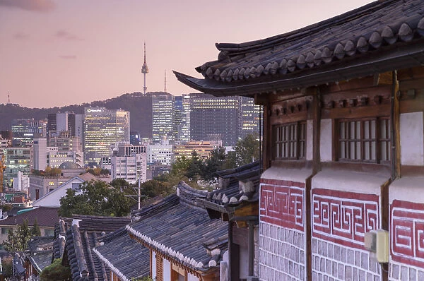 Traditional houses in Bukchon Hanok village and Namsan Seoul Tower at dusk, Seoul