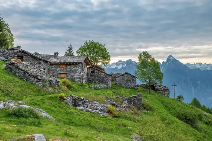 Framed Print : Traditional stone huts with high peak Pizzo di Prata in background, Alpe Buglio