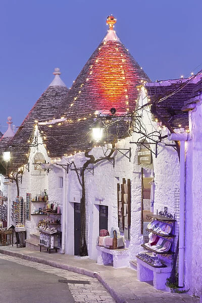 Traditional trullo house illuminated by christmas lights