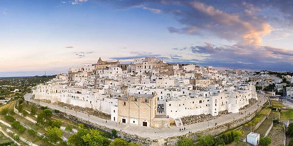 Traditional white buildings of Ostuni at sunset, aerial view, province of Brindisi