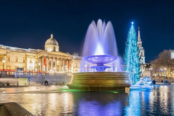 Trafalgar Square illuminated at night at Christmas, London, England, UK