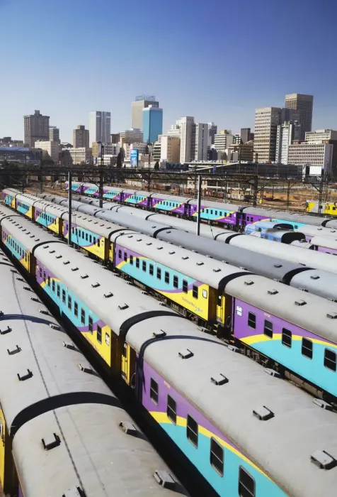 Framed Print : Train carriages at Park Station with city skyline in background, Johannesburg, Gauteng Framed Print : Train carriages at Park Station with city skyline in background, Johannesburg, Gauteng