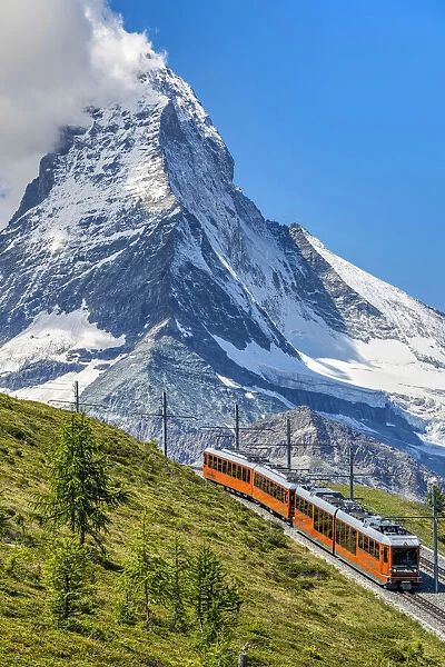 Train along the Gornergrat mountain rack railway with Matterhorn in the foreground