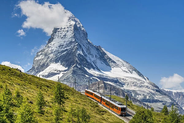 Train along the Gornergrat mountain rack railway with Matterhorn in the foreground