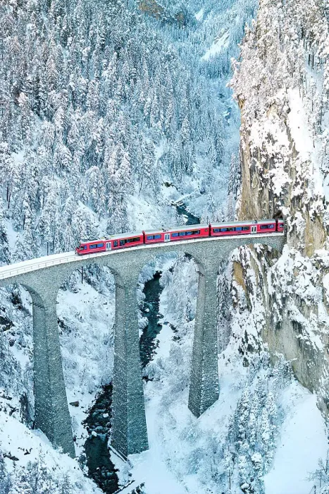 Framed Print : Train on Landwasser viaduct entering in a tunnel carved into a snowy mountain ridge, Filisur, Graubunden canton, Switzerland Framed Print : Train on Landwasser viaduct entering in a tunnel carved into a snowy mountain ridge, Filisur, Graubunden canton, Switzerland
