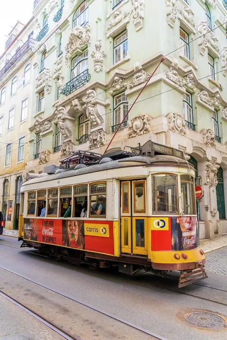 Framed Print : Tram passing a beautiful building in Lisbon, Portugal, Europe Framed Print : Tram passing a beautiful building in Lisbon, Portugal, Europe
