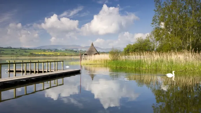 Framed Print : Tranquil morning on Llangorse Lake, with views to the Iron Age Crannog and Pen y Fan Framed Print : Tranquil morning on Llangorse Lake, with views to the Iron Age Crannog and Pen y Fan