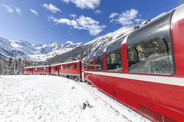 Transit of Bernina Express train at Montebello curve with view on Morterasch glacier