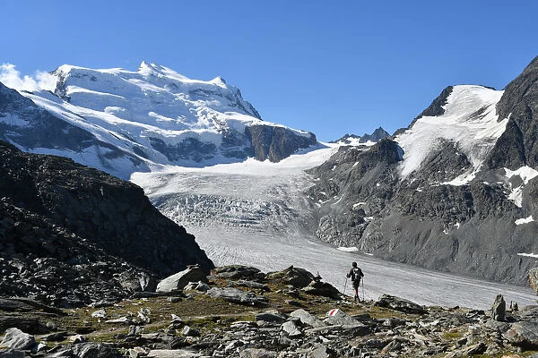 Trekker with Grand Combin on background, Switzerland, Swiss