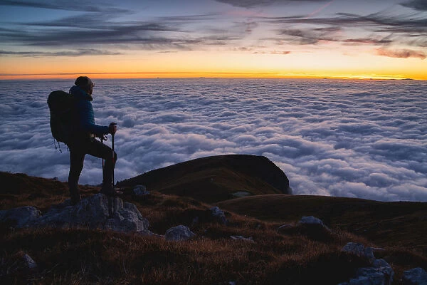 Trekker at Sunset from Mount Guglielmo above the Clouds, Brescia province, Lombardy