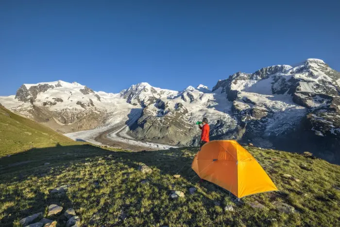 Framed Print : A trekker is in front of the Swiss side of Monte Rosa Massif close to Riffelsee Lake
