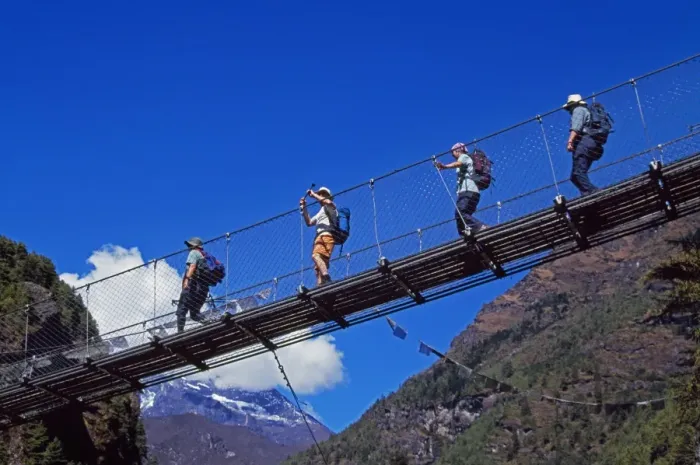 Framed Print : Trekkers crossing a suspension bridge over the Dudh Kosi river Framed Print : Trekkers crossing a suspension bridge over the Dudh Kosi river