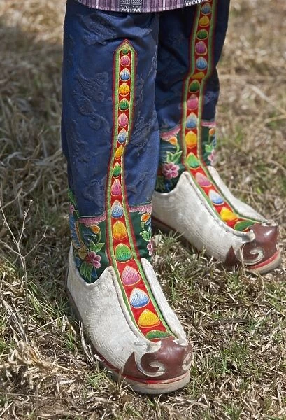 Tsholham - traditional knee-length boots that are worn by Bhutanese men during important ceremonial occasions. They are commonly hand-stitched from cow or sheep hide and decorated with brocade