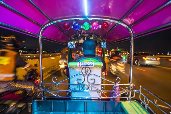 Tuk-tuk travelling through the streets of Bangkok, Thailand