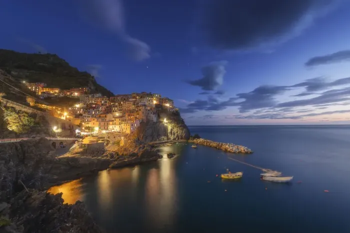 Framed Print : Twilight in Manarola, Cinque Terre, the most beautiful moment of the day when the lights of the town come