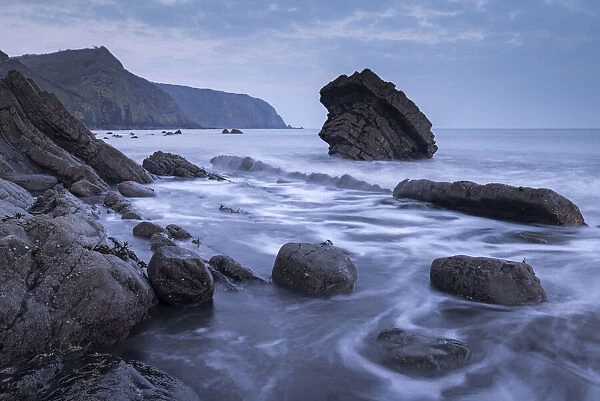 Twilight over the rocky shores of Mouthmill Beach on the North Devon coast, England