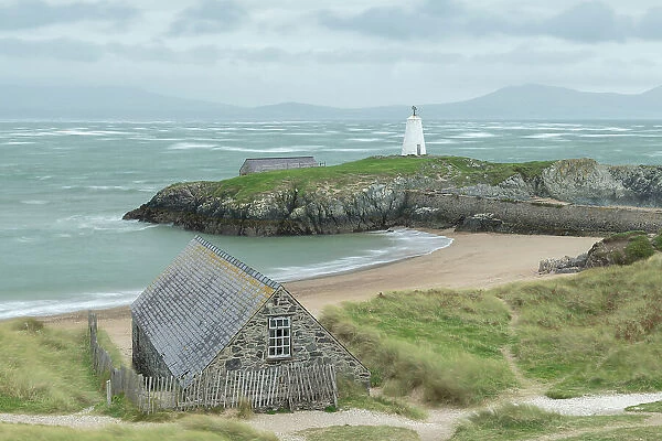Twr Bach Lighthouse and the old lifeboat station on Llanddwyn Island off the coast of Anglesey, Wales, UK. Autumn (October) 2023