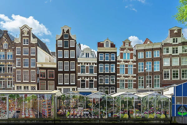 Typical houses and flower market Bloemenmarkt on Singel canal, Amsterdam, Netherlands