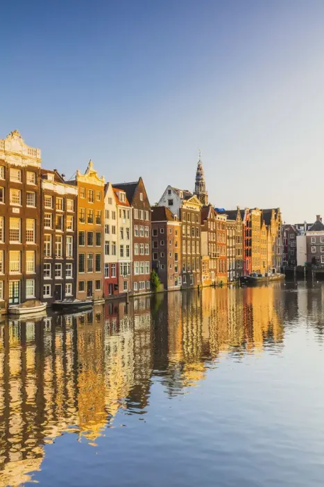 Framed Print : Typical houses reflecting in Damrak water canal at sunset in Amsterdam