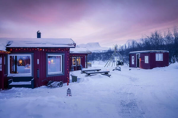 Typical village in the Arctic Circle, Swedish Lapland, Abisko. Christmas time at sunset