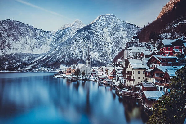 Typical village called Hallstatt con the Hallstatter see at sunrise with the houses