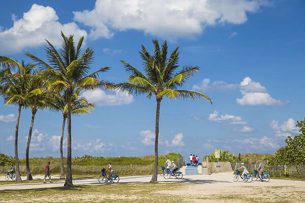 U. S. A, Miami, Miami beach, South Beach, Tourists riding Citi bikes at beach front