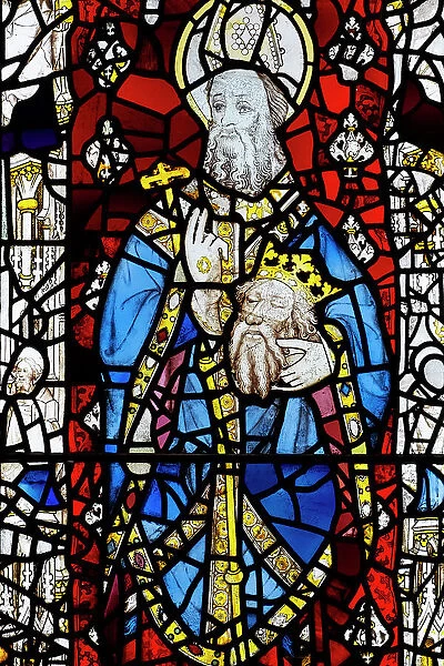 UK, England, English; British; York, York Minster, medieval stained glass; 15th century window; Seventh Century abbot of Lindisfarne St. Cuthbert carrying head of St. Oswald