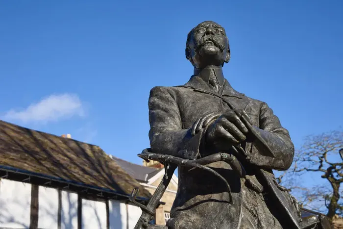 Framed Print : UK, England, Herefordshire, Hereford, Edward Elgar Statue leaning against a bicycle infront of Cathedral barn