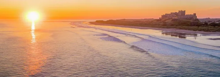 Framed Print : UK, England, Northumberland, Bamburgh, Bamburgh Beach, Bamburgh Castle at sunrise