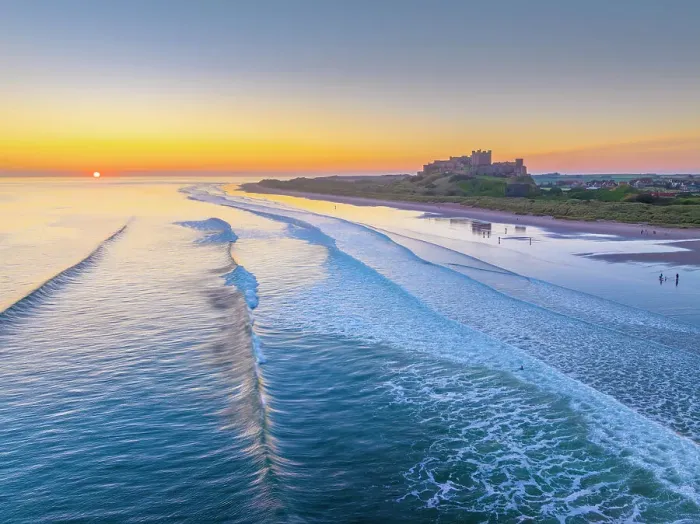 Framed Print : UK, England, Northumberland, Bamburgh, Bamburgh Beach, Bamburgh Castle at sunrise