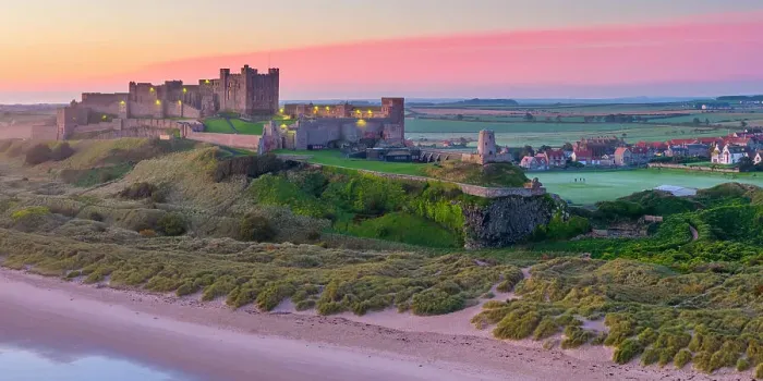 Framed Print : UK, England, Northumberland, Bamburgh, Bamburgh Beach, Bamburgh Castle at sunrise