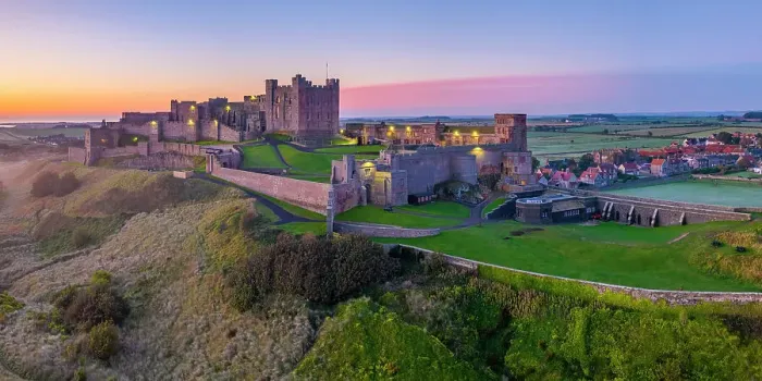 Framed Print : UK, England, Northumberland, Bamburgh, Bamburgh Beach, Bamburgh Castle at sunrise