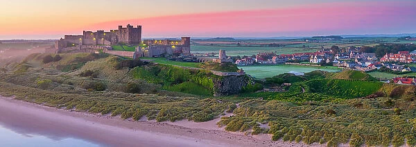 UK, England, Northumberland, Bamburgh, Bamburgh Beach, Bamburgh Castle at sunrise