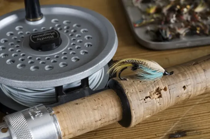 Framed Print : UK. A salmon fly stuck into the cork handle of a fly fishing rod Framed Print : UK. A salmon fly stuck into the cork handle of a fly fishing rod
