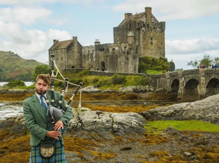 Framed Print : UK, Scotland, Highlands, Dornie, Man in Highland Dress playing bigpipe in front of Framed Print : UK, Scotland, Highlands, Dornie, Man in Highland Dress playing bigpipe in front of
