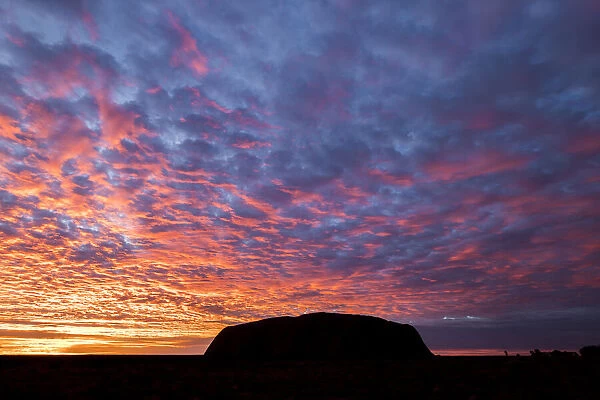 Uluru (Ayers Rock) silhouetted at sunrise, Uluru Kata Tjuta National Park