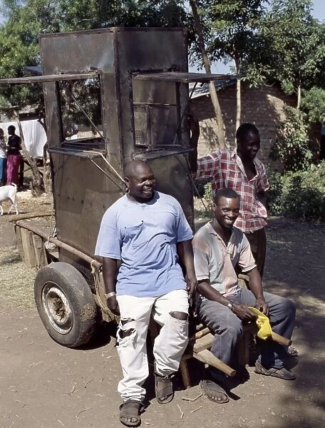 An unfinished mobile phone kiosk is carried on a mkokoteni