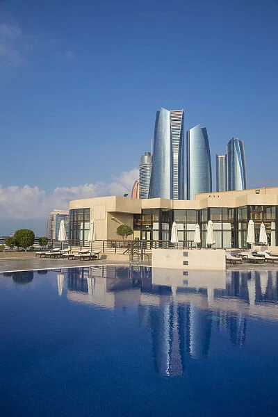 United Arab Emirates, Abu Dhabi, United Etihad Towers reflecting in outdoor swimming