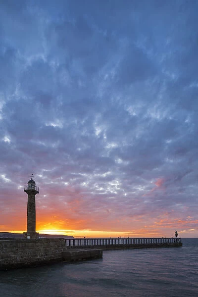United Kingdom, England, North Yorkshire, Whitby. The West Pier at sunset