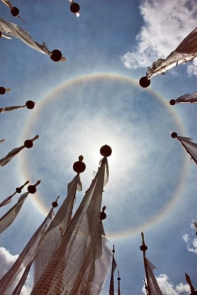 A very unusual full circle rainbow phenomenon surrounded by lungdhar Buddhist prayer flags
