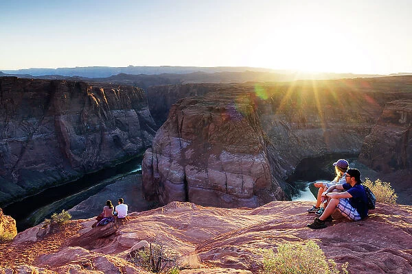 USA, Arizona, Page, tourists enjoying the elevated view of the Horse Shoe Bend at sunset