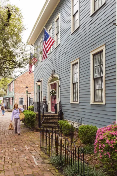 Framed Print : USA, Georgia, Savannah Woman walking past a typical house Framed Print : USA, Georgia, Savannah Woman walking past a typical house