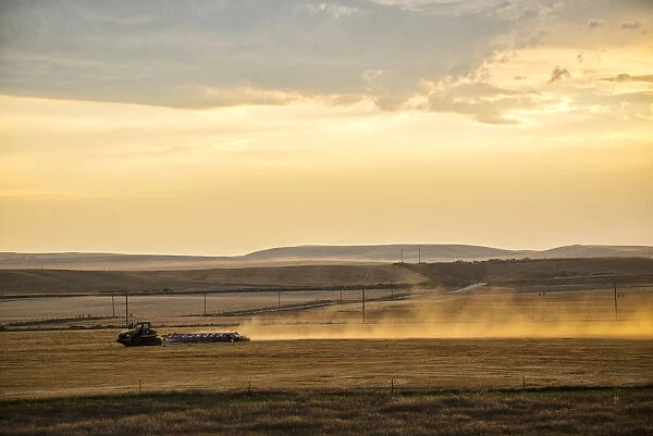 USA, Montana, Bozeman, tractor plowing field