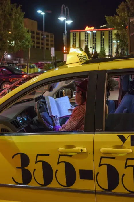 Framed Print : USA, Nevada, Reno, woman cabbie reading in cab at night Framed Print : USA, Nevada, Reno, woman cabbie reading in cab at night