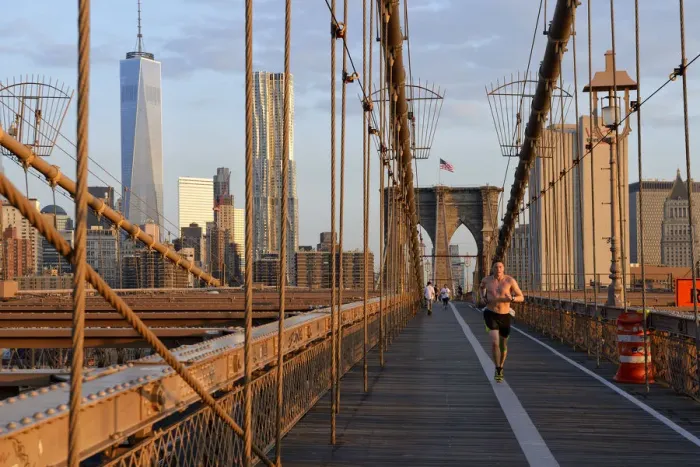Framed Print : USA, New York, Brooklyn Bridge, man running over Brooklyn brighe in the morning