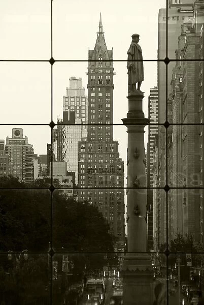 USA, New York City, Manhattan, Statue of Christopher Columbus in Columbus Circle viewed through a glass shopping