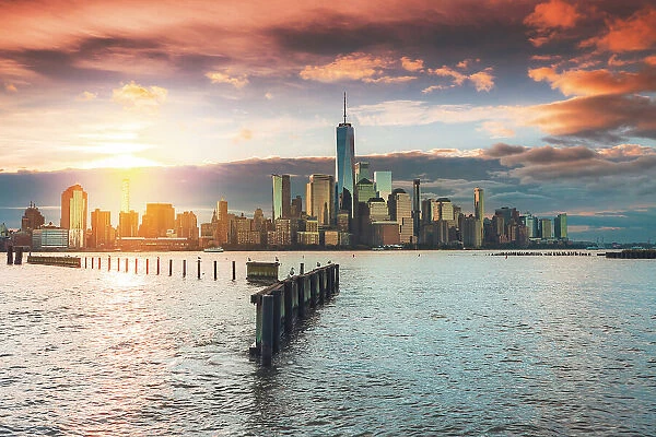 USA, New York City, View of New York city from Jersey city with the sun rising above the Financial district